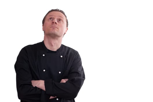 A man as a cook looks up thoughtfully