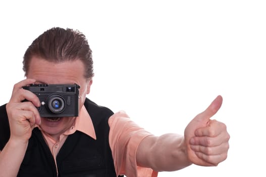 A male photographer with a viewfinder camera holds a thumbs up