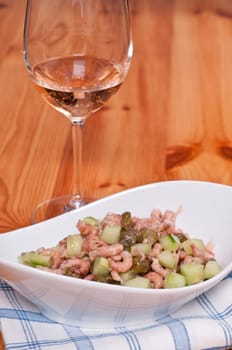 Salad of North Sea crabs,cucumber and capers and a glass of rosé wine