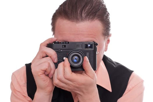 A male photographer focuses on his camera