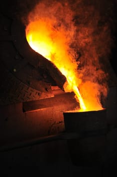 Foundry - molten metal poured from ladle for casting