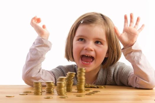 Girl sits jubilantly in front of several stacks of money