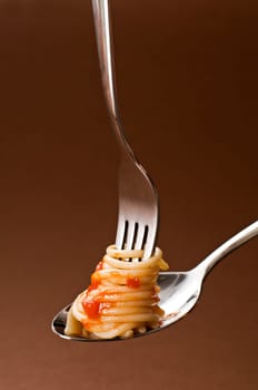 Spaghetti with tomato on fork close up shoot