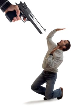 a pistol aiming to a business man concept on white