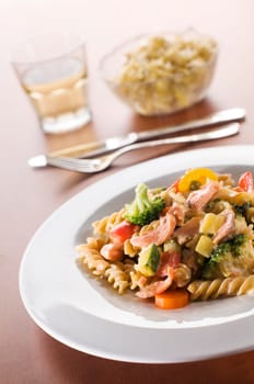 Fresh pasta with smoked salmon and vegetables in cream sauce