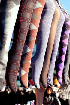 colorful tights in a row hanging in an outdoor market