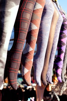 colorful tights in a row hanging in an outdoor market