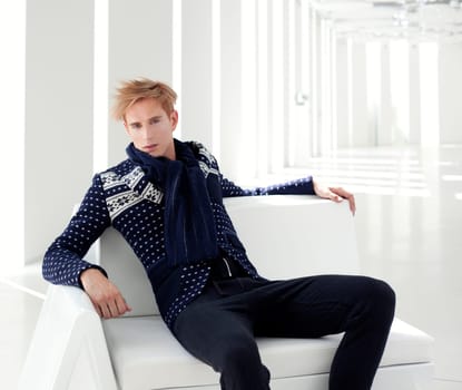 modern blond male futuristic sci-fi sitting in white indoor