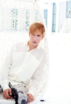blond modern man portrait in summer terrace vampire inspiration