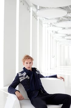 modern blond male futuristic sci-fi sitting in white indoor