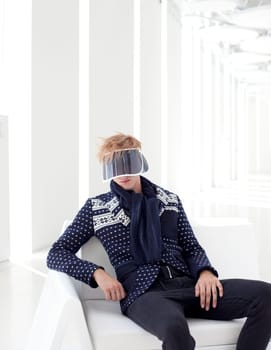 modern male model with futuristic sci-fi visor sitting in white indoor