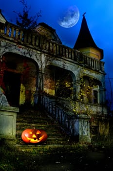 old house in the night with halloween pumpkin