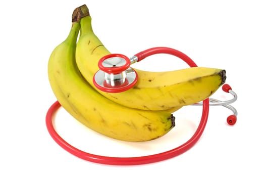 Bananas and Stethoscope over a white background