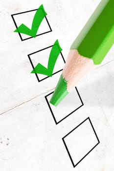 marked check boxes and big green pencil
