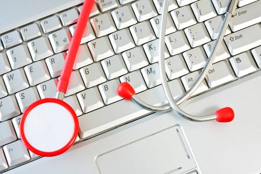 Concept for online medicine or IT support . Computer keyboard with a stethoscope.