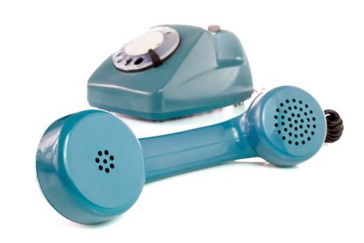 old blue telephone over a white background