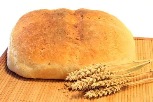 freshly baked bread with ears of wheat