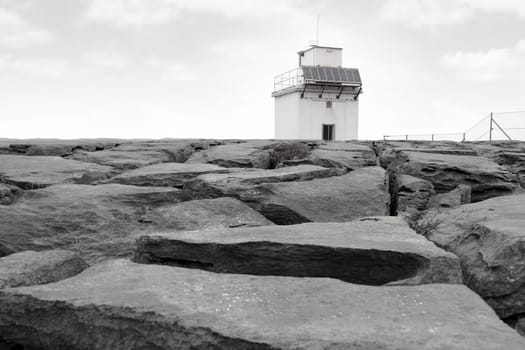 lighthouse on rocky landscape of the burren in county clare ireland