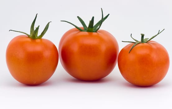 three red tomato vegetable isolated on white background