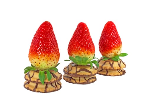 Three fresh ripe strawberry on a cakes in a row isolated on white background