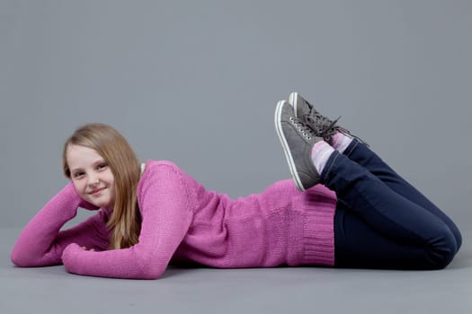 young happy girl.  little girl on a gray background