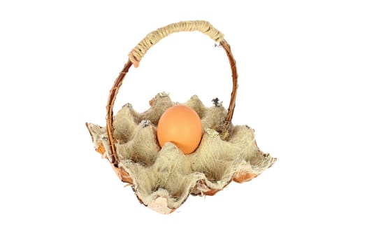 Chicken egg in a basket made of natural materials, isolated