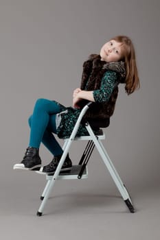 young happy girl.  little girl on a gray background