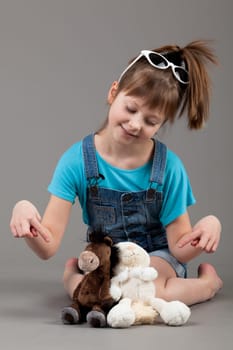 young happy girl.  little girl on a gray background
