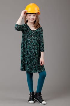 young happy girl.  little girl on a gray background