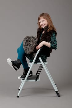 young happy girl.  little girl on a gray background