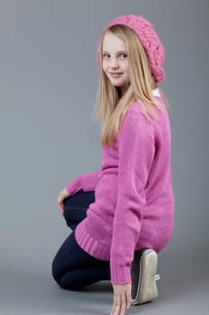 young happy girl.  little girl on a gray background
