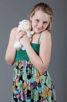 young happy girl.  little girl on a gray background