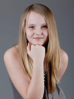 young happy girl.  little girl on a gray background