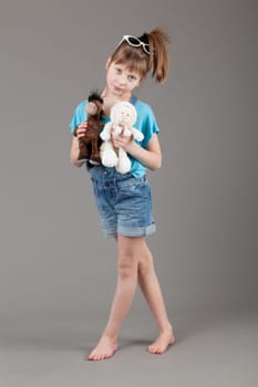 young happy girl.  little girl on a gray background
