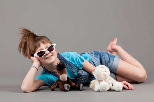young happy girl.  little girl on a gray background