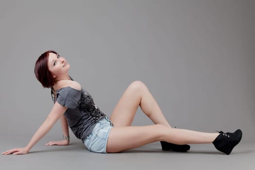 attractive smiling woman. Portrait of an attractive young woman.  lady posing on grey background.