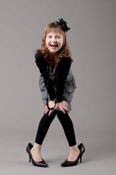 young happy girl.  little girl on a gray background