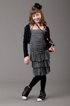 young happy girl.  little girl on a gray background