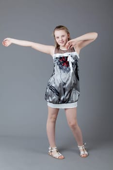 young happy girl.  little girl on a gray background
