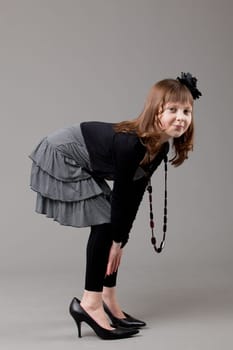 young happy girl.  little girl on a gray background