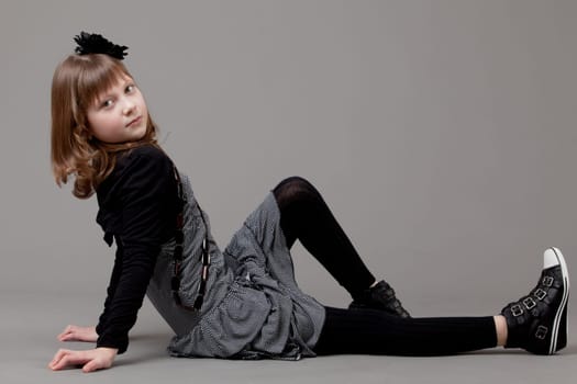 young happy girl.  little girl on a gray background