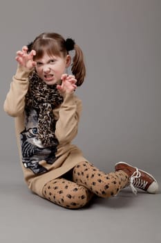 young happy girl.  little girl on a gray background
