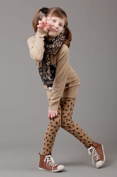 young happy girl.  little girl on a gray background