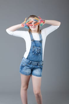 young happy girl.  little girl on a gray background