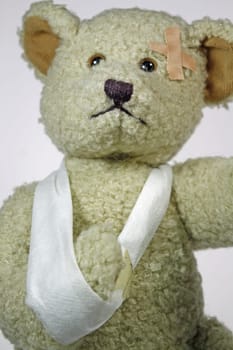 Injured teddy bear with arm sling