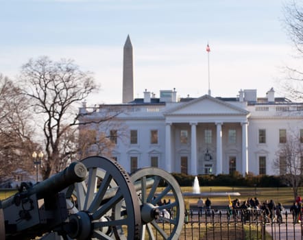 Civil war cannons guard the front of the White House with Washington Monument in distance