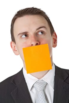 Businessman with postit note on mouth