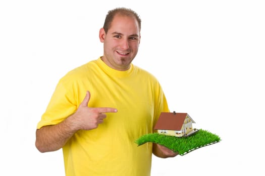 Young man with model house - isolated on white background