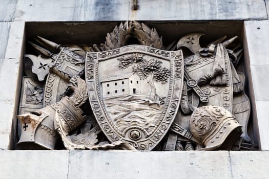 Shield, Helmets and Sword Marble Relief in Genoa, Italy