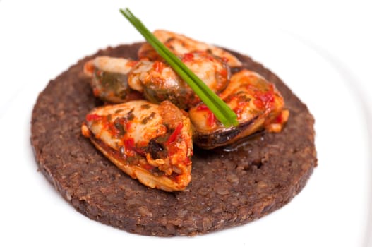 Canape with pumpernickel and mussels and chives